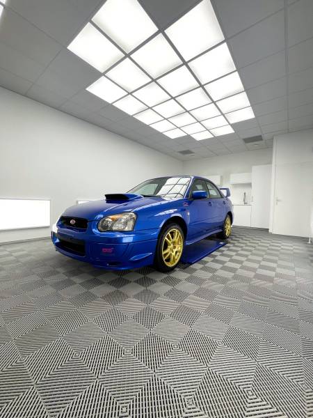 PREPARATION ESTHETIQUE, POSE D'UNE CIRE et fourniture d'une HOUSSE D'INTERIEUR sur une SUBARU IMPREZA WRX STI de 2003 à CULOZ dans l'AIN..