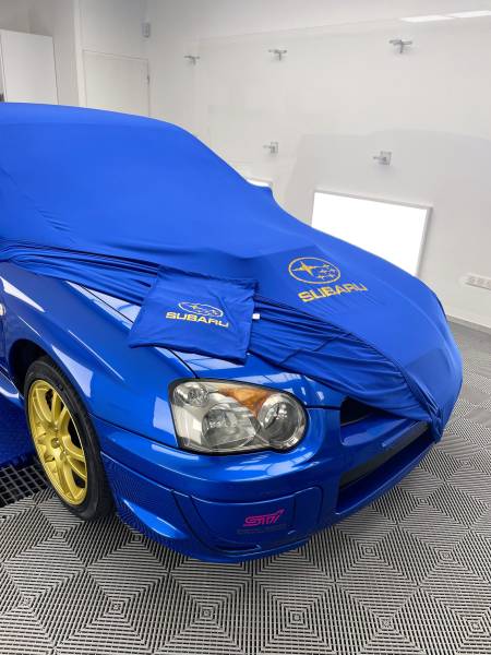 PREPARATION ESTHETIQUE, POSE D'UNE CIRE et fourniture d'une HOUSSE D'INTERIEUR sur une SUBARU IMPREZA WRX STI de 2003 à CULOZ dans l'AIN..